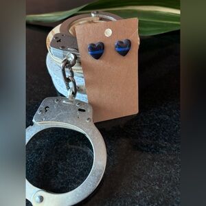 New. Unused. Thin blue line heart shaped stud earrings